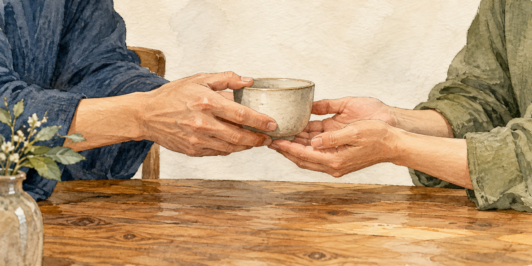 Hands gently pass a plain ceramic cup across a wooden table.